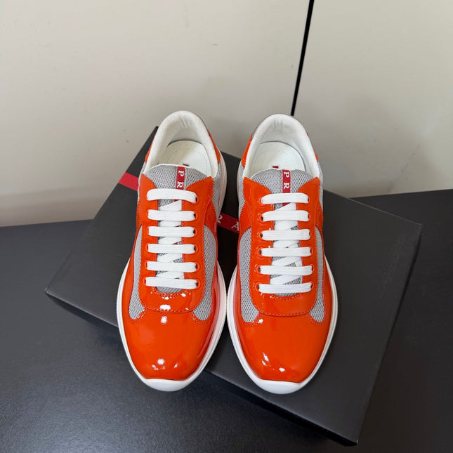 PRADA 26S SNEAKERS IN RED ORANGE PATENT CALFSKIN AND WHITE MESH