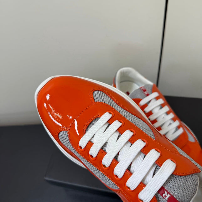 PRADA 26S SNEAKERS IN RED ORANGE PATENT CALFSKIN AND WHITE MESH