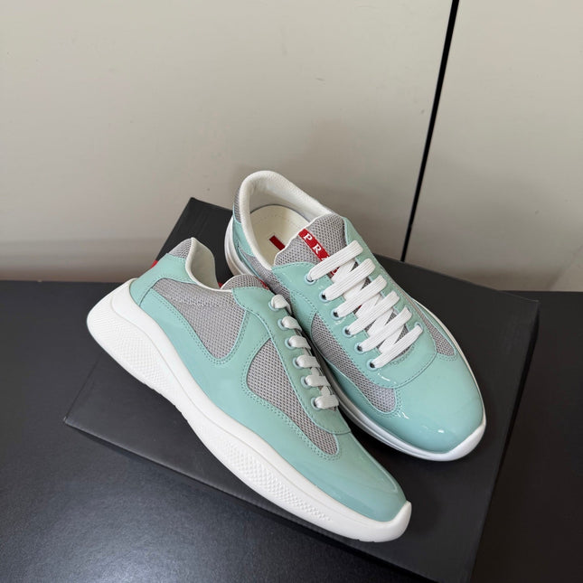 PRADA 26S SNEAKERS IN SOFT TEAL PATENT CALFSKIN AND WHITE MESH