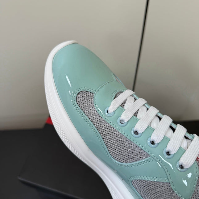 PRADA 26S SNEAKERS IN SOFT TEAL PATENT CALFSKIN AND WHITE MESH
