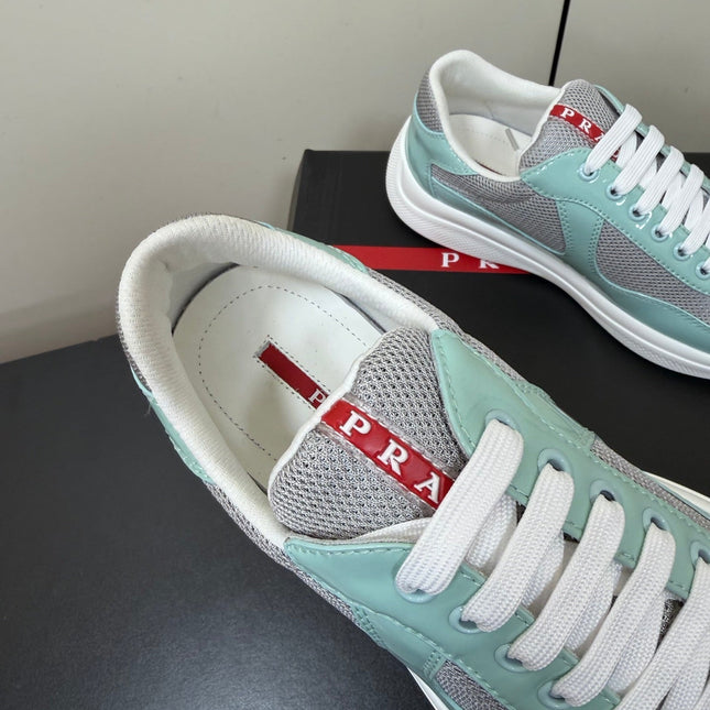 PRADA 26S SNEAKERS IN SOFT TEAL PATENT CALFSKIN AND WHITE MESH