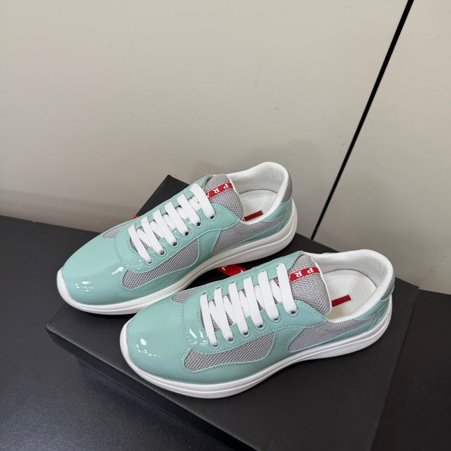 PRADA 26S SNEAKERS IN SOFT TEAL PATENT CALFSKIN AND WHITE MESH