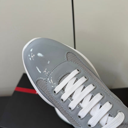 PRADA 26S SNEAKERS IN LIGHT GRAY PATENT CALFSKIN AND WHITE MESH