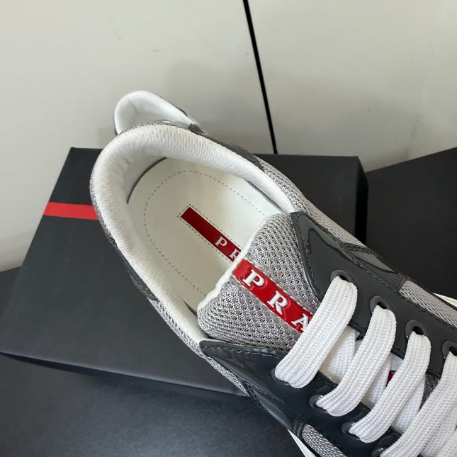 PRADA 26S SNEAKERS IN GRAY PATENT CALFSKIN AND WHITE MESH