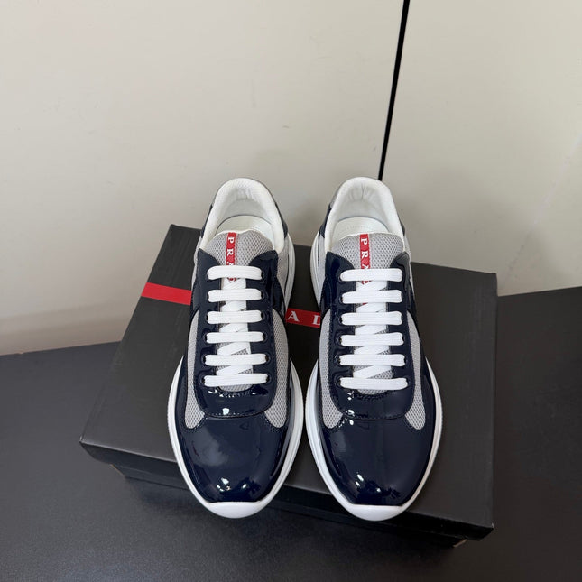 PRADA 26S SNEAKERS IN NAVY BLUE PATENT CALFSKIN AND WHITE MESH