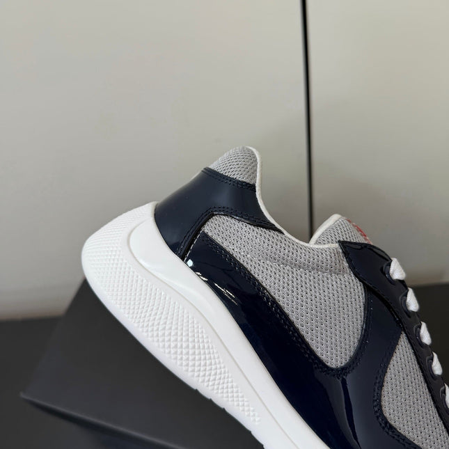 PRADA 26S SNEAKERS IN NAVY BLUE PATENT CALFSKIN AND WHITE MESH