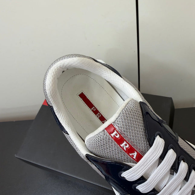 PRADA 26S SNEAKERS IN NAVY BLUE PATENT CALFSKIN AND WHITE MESH