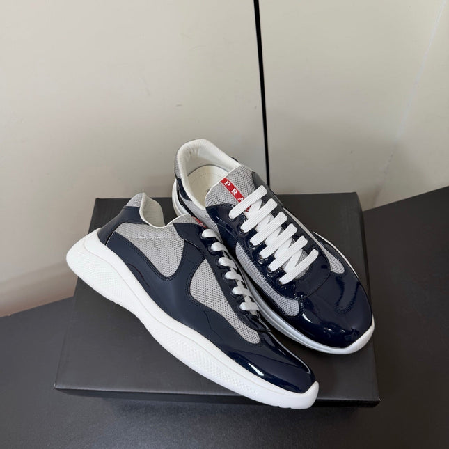 PRADA 26S SNEAKERS IN NAVY BLUE PATENT CALFSKIN AND WHITE MESH