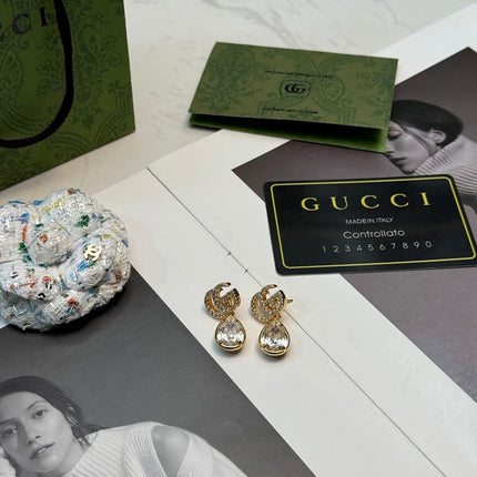 GUCCI 26S INTERLOCKING GG CRYSTAL TEARDROP EARRINGS IN GOLD TONE METAL 621443