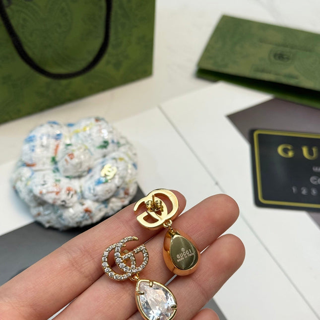 GUCCI 26S INTERLOCKING GG CRYSTAL TEARDROP EARRINGS IN GOLD TONE METAL 621443