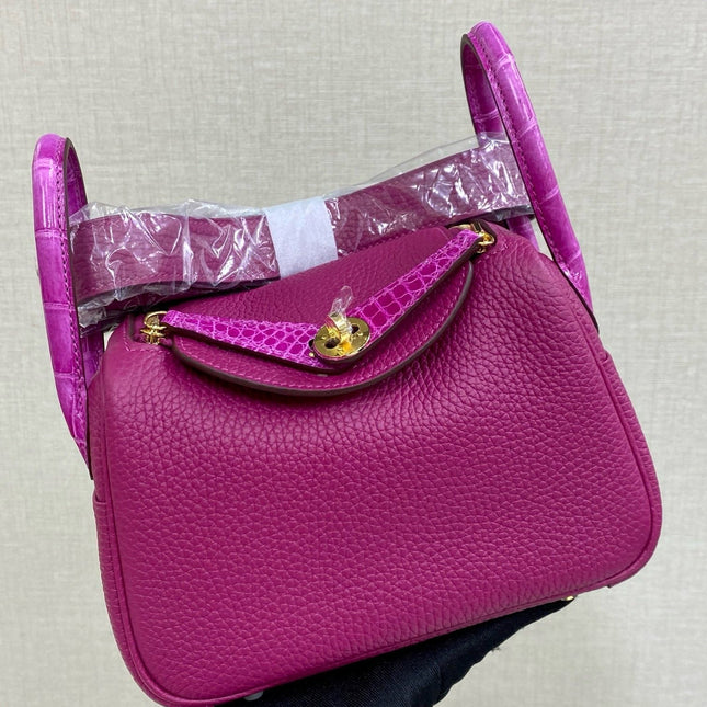 HM 25S MINI LINDY 19 CM IN DARK PINK COWHIDE WITH CROCODILE HANDLE AND GOLD HARDWARE
