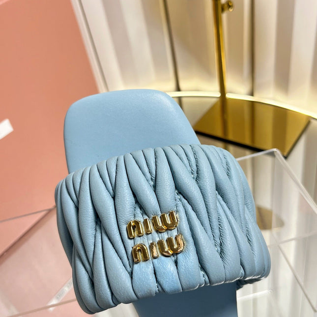 MIUMIU 26S MATELASSE SLIDES IN LIGHT BLUE CALFSKIN GOLD HARDWARE