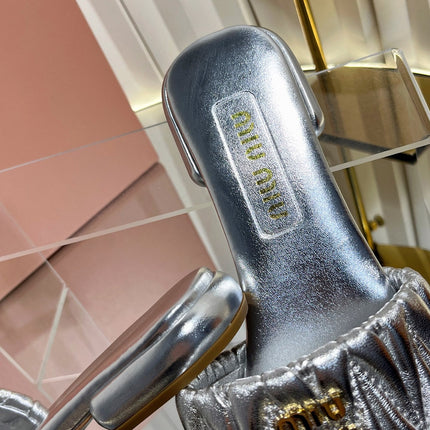 MIUMIU 26S MATELASSE SLIDES IN SILVER CALFSKIN GOLD HARDWARE