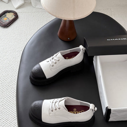CHANEL 26S LACE UP PLATFORM IN BLACK AND WHITE CALFSKIN