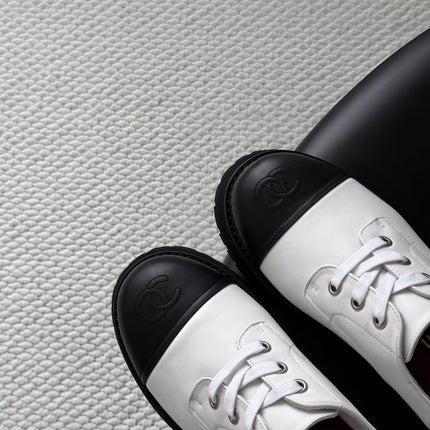 CHANEL 26S LACE UP PLATFORM IN BLACK AND WHITE CALFSKIN