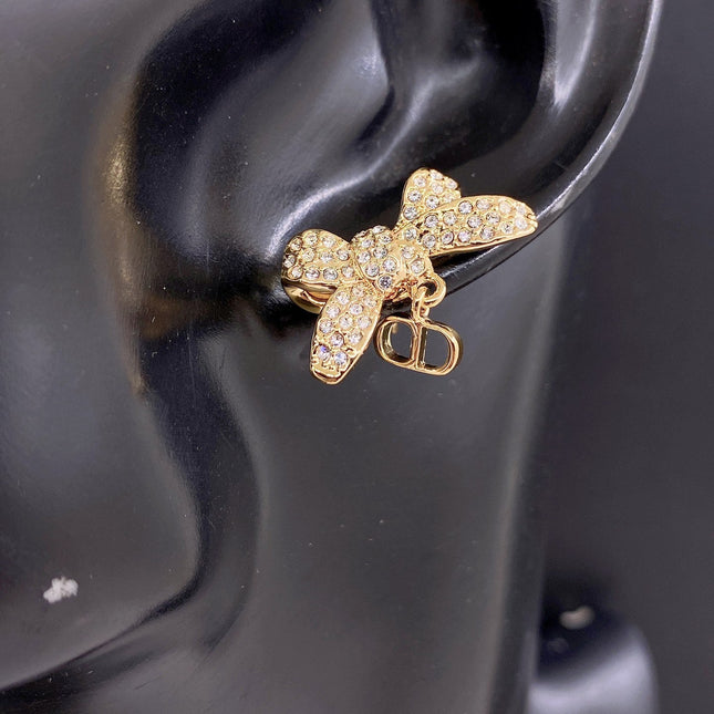 CD 26S CRYSTAL BOW PEARL DROP EARRINGS IN GOLD TONE METAL 644377