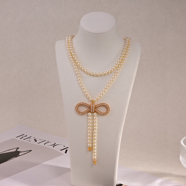 CD 26S PEARL BOW DROP STATEMENT NECKLACE IN GOLD TONE METAL 629848