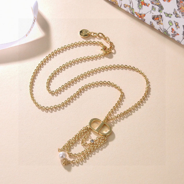 CD 26S PEARL CHAIN DROP LOGO NECKLACE IN GOLD TONE METAL WITH WHITE RESIN PEARL & CRYSTAL 631060