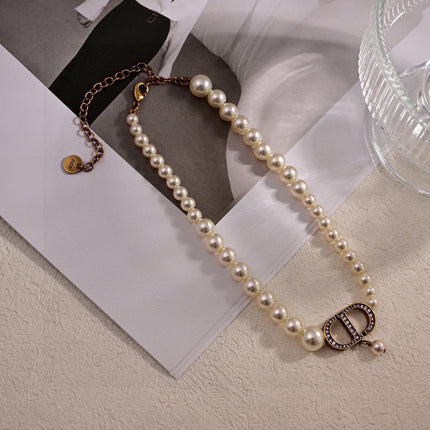 CD 26S PEARL STRAND CD CRYSTAL LOGO DROP NECKLACE IN GOLD TONE METAL 631858