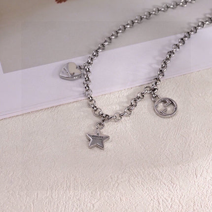 GUCCI 26S INTERLOCKING G LOGO STAR HEART MULTI CHARM CHAIN BRACELET IN SILVER TONE METAL