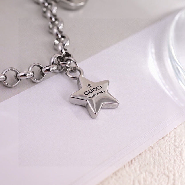 GUCCI 26S INTERLOCKING G LOGO STAR HEART MULTI CHARM CHAIN BRACELET IN SILVER TONE METAL