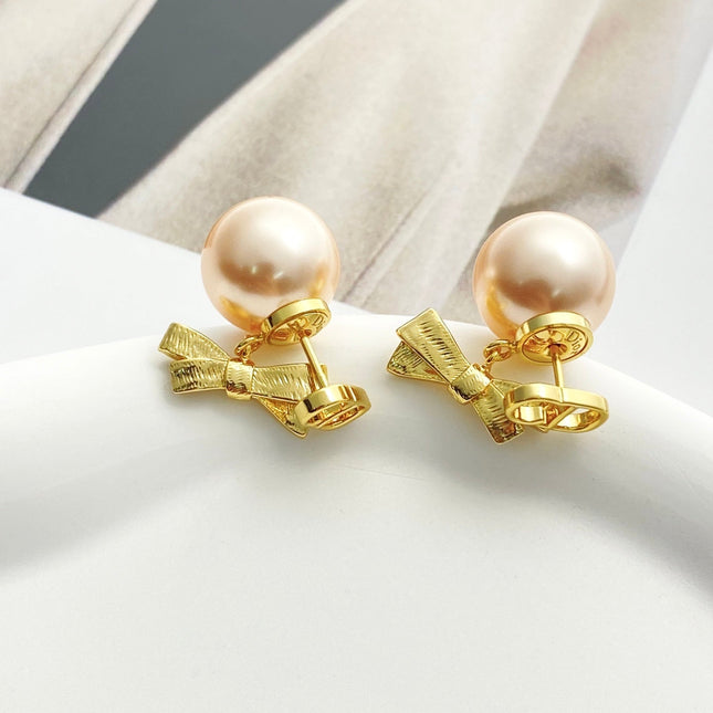 CD 26S PEARL BOW DROP EARRINGS IN GOLD TONE METAL 644484