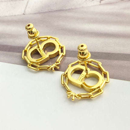 CD 26S CRYSTAL CHAIN LOGO STUD EARRINGS IN GOLD TONE METAL 645655
