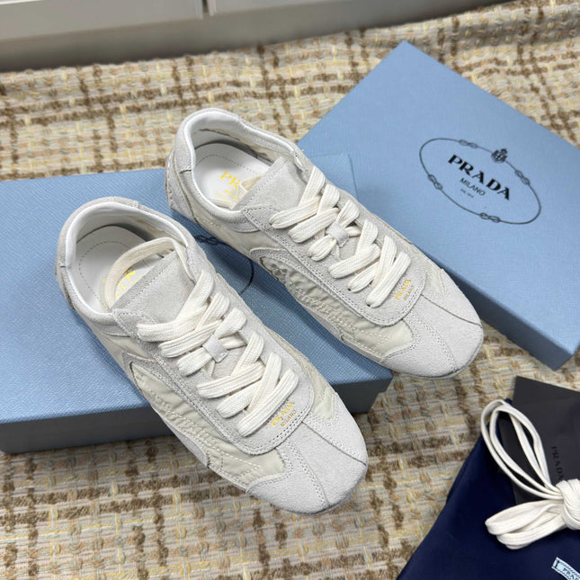 PRADA 26S LOW TOP SNEAKERS IN WHITE NYLON AND SUEDE