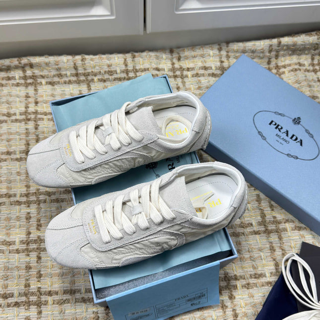 PRADA 26S LOW TOP SNEAKERS IN WHITE NYLON AND SUEDE