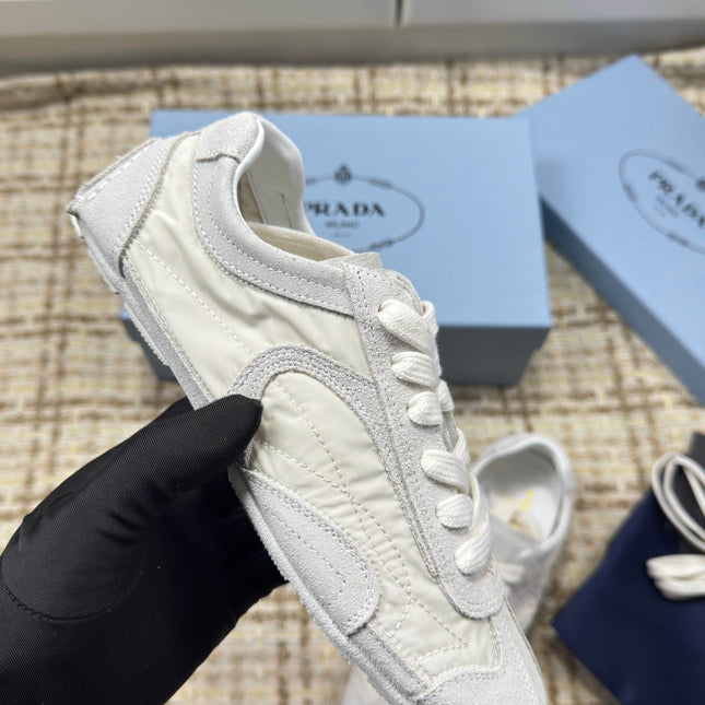 PRADA 26S LOW TOP SNEAKERS IN WHITE NYLON AND SUEDE