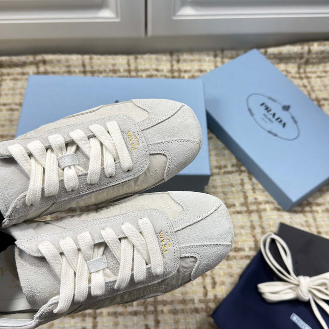 PRADA 26S LOW TOP SNEAKERS IN WHITE NYLON AND SUEDE