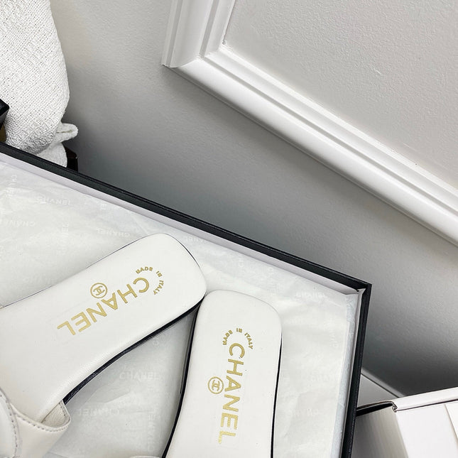 CHANEL CC LOGO MULES IN WHITE CALFSKIN