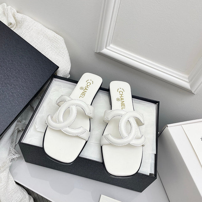 CHANEL CC LOGO MULES IN WHITE CALFSKIN