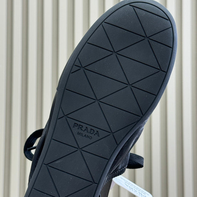 PRADA 25S COLLAPSE MULES IN BLACK CALFSKIN