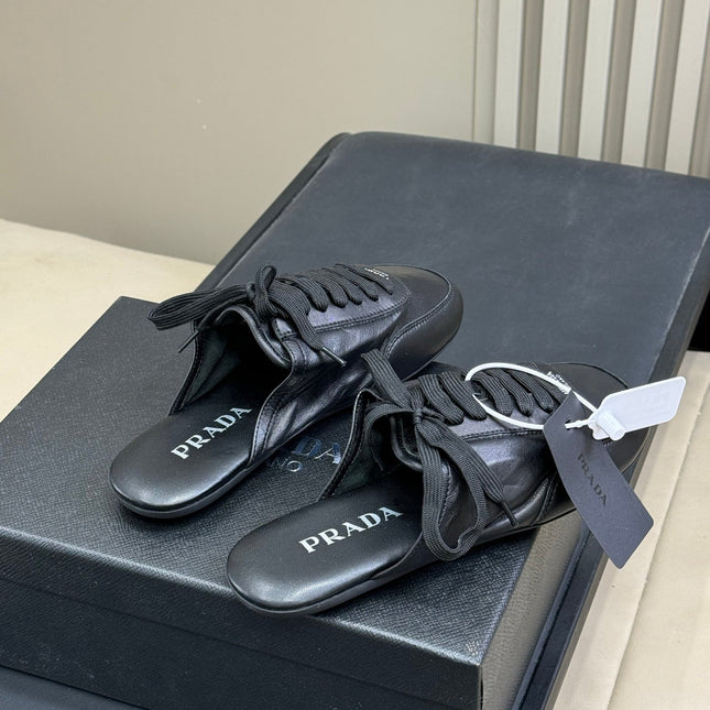 PRADA 25S COLLAPSE MULES IN BLACK CALFSKIN