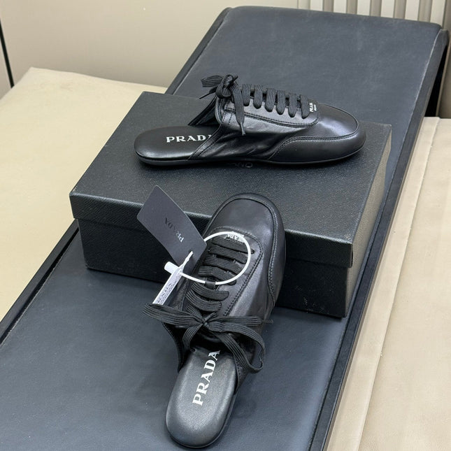 PRADA 25S COLLAPSE MULES IN BLACK CALFSKIN
