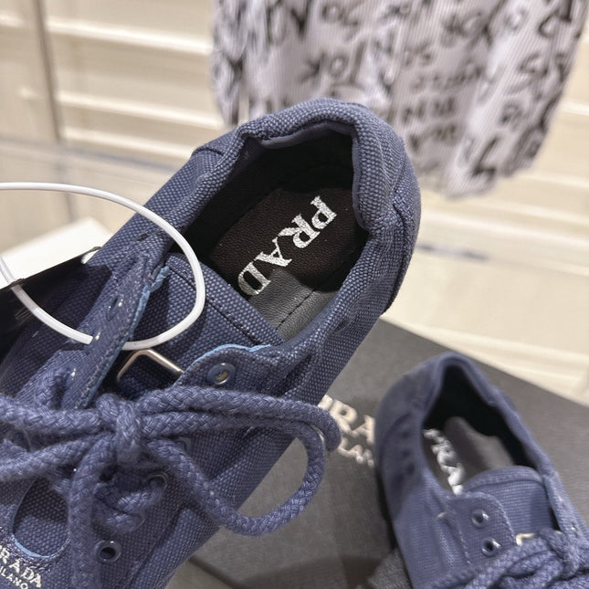 PRADA 26S COLLAPSE SNEAKERS IN BLUE CANVAS