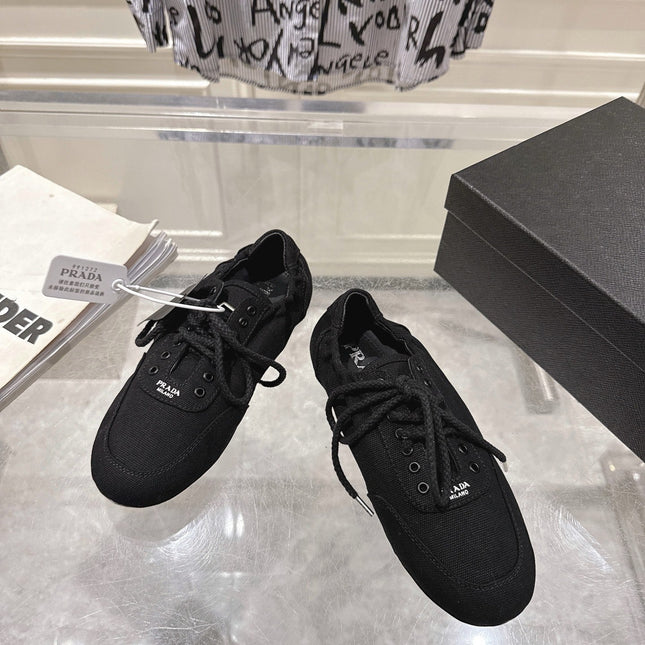 PRADA 26S COLLAPSE SNEAKERS IN BLACK CANVAS