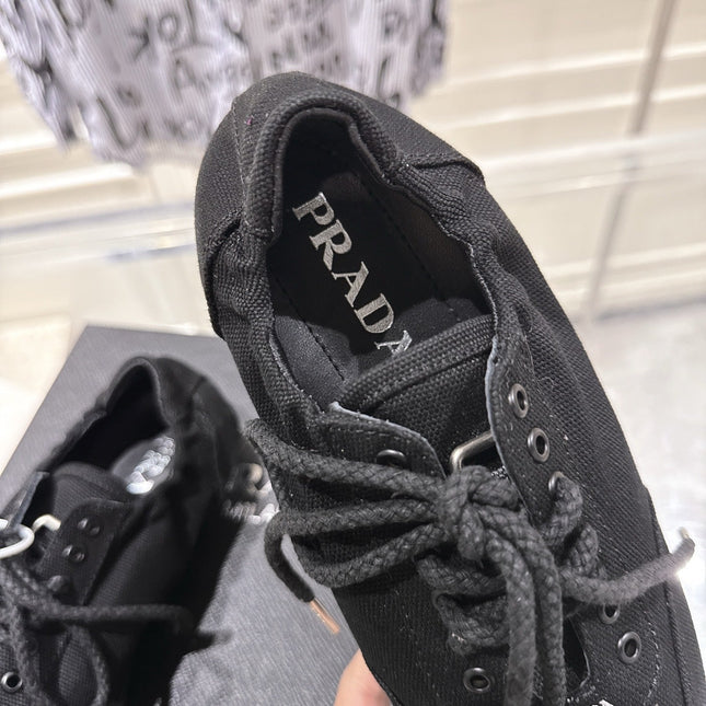 PRADA 26S COLLAPSE SNEAKERS IN BLACK CANVAS