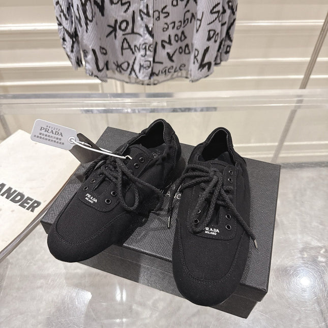 PRADA 26S COLLAPSE SNEAKERS IN BLACK CANVAS