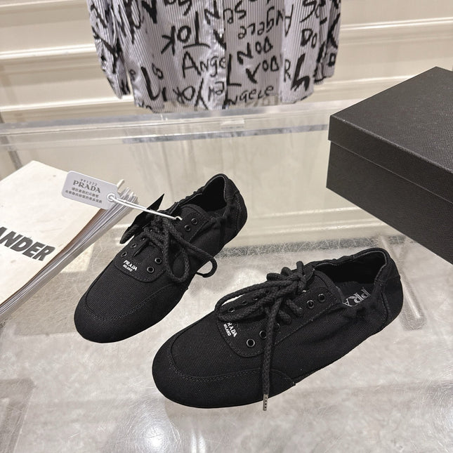 PRADA 26S COLLAPSE SNEAKERS IN BLACK CANVAS