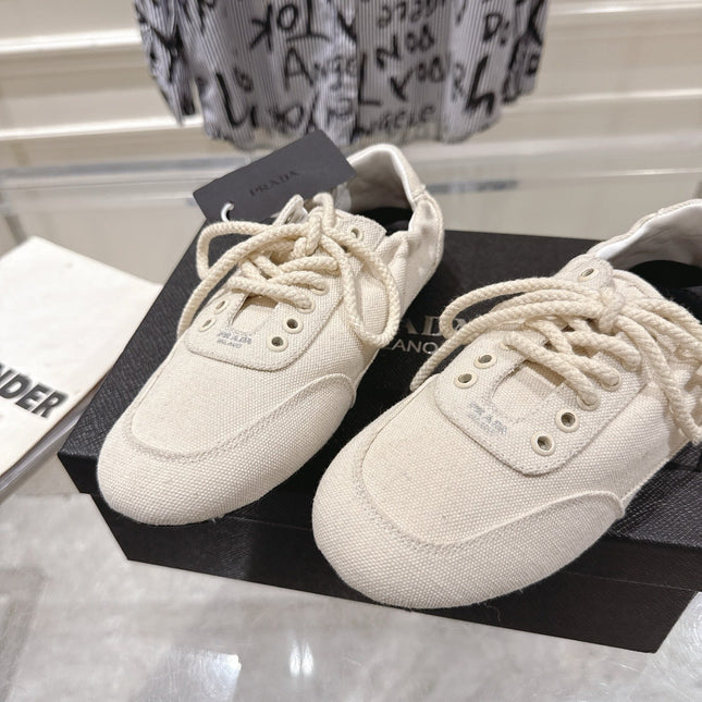 PRADA 26S COLLAPSE SNEAKERS IN WHITE CANVAS