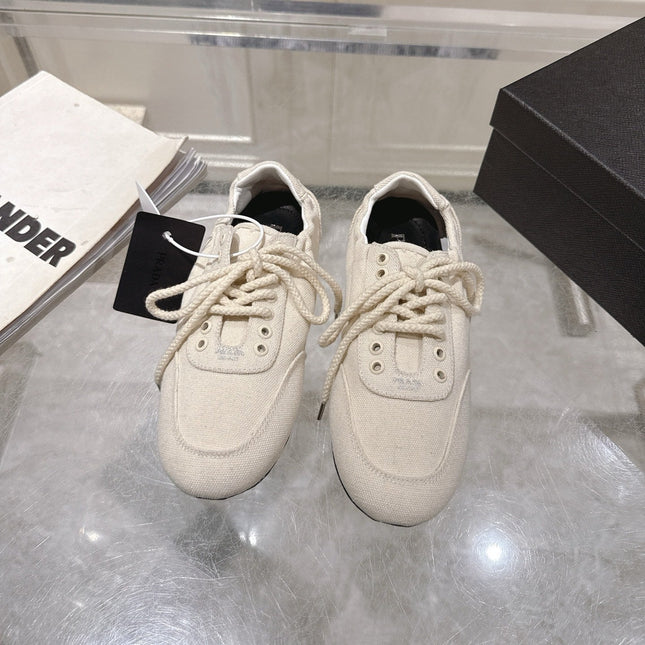 PRADA 26S COLLAPSE SNEAKERS IN WHITE CANVAS