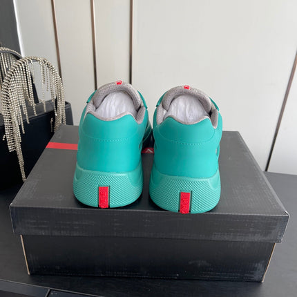 PRADA 26S AMERICA CUP SNEAKERS IN TEAL BLUE SOFT RUBBER AND BIKE FABRIC