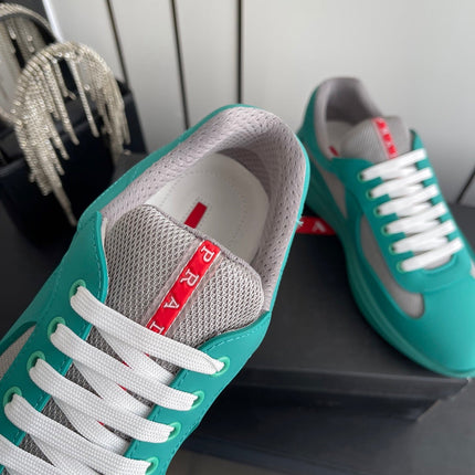 PRADA 26S AMERICA CUP SNEAKERS IN TEAL BLUE SOFT RUBBER AND BIKE FABRIC
