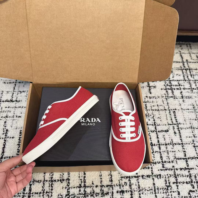 PRADA 26S LACE UP SNEAKERS IN RED CANVAS