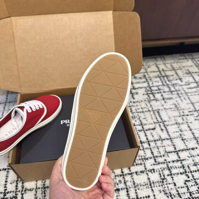 PRADA 26S LACE UP SNEAKERS IN RED CANVAS