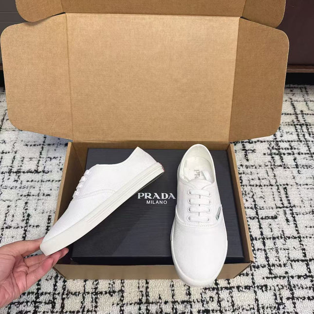 PRADA 26S LACE UP SNEAKERS IN WHITE CANVAS