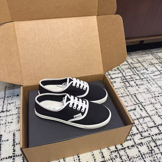 PRADA 26S LACE UP SNEAKERS IN BLACK AND WHITE CANVAS