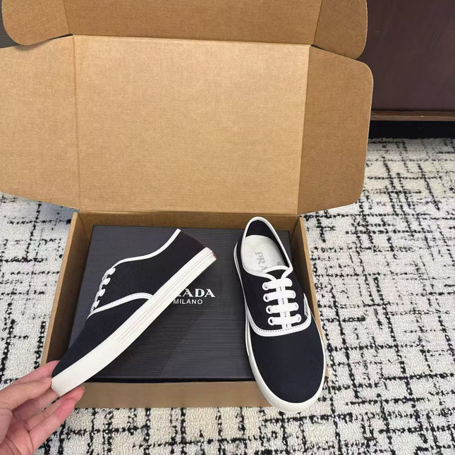 PRADA 26S LACE UP SNEAKERS IN BLACK AND WHITE CANVAS